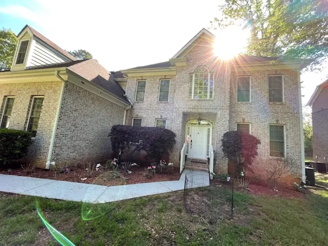 The same brick home before painting